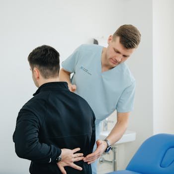 pexels-photo-20860586-20860586 Physiotherapist assisting a patient with back pain in a clinic setting.